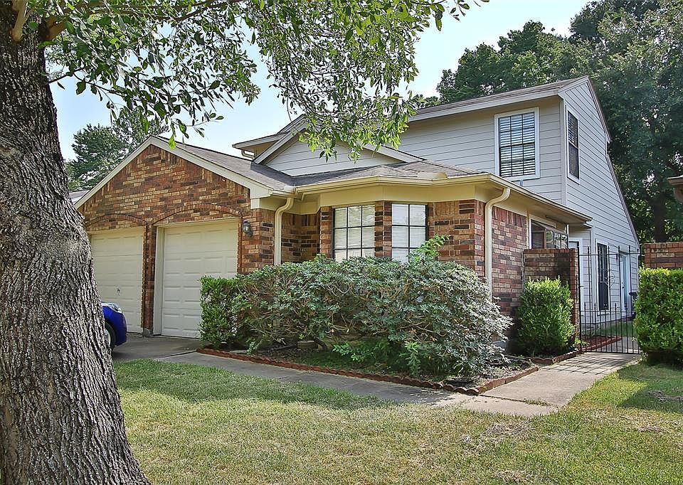 VERY PRETTY ELEVATION! THIS HOUSE HAS SO MUCH PERSONALITY WITH THE PRETTY BRICK, BAY WINDOW IN FRONT, ROOF PEAKS AND WALKWAY TO SIDE COURTYARD AND DOOR!!