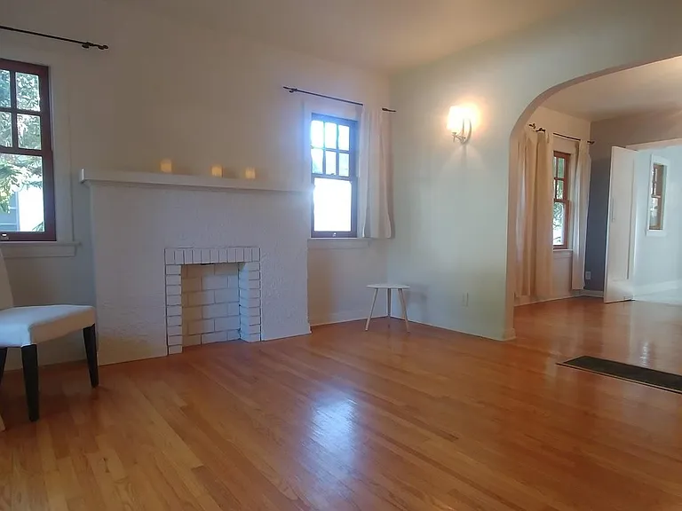 Living Room with faux fireplace and bright, decorative wall sconces.