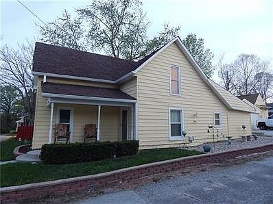 Front of home shows nice front porch, new retainer wall