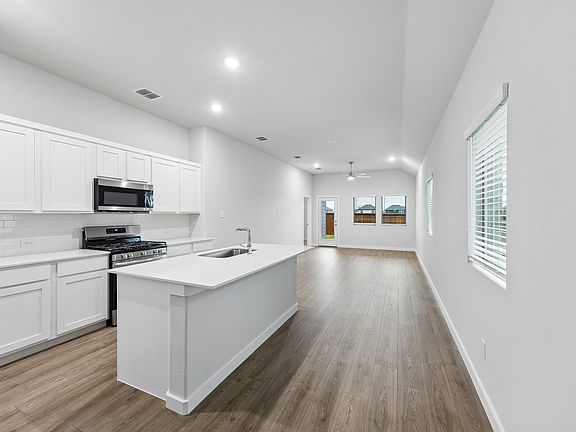 Kitchen in the Cedar home plan by Trophy Signature Homes - REPRESENTATIVE PHOTO