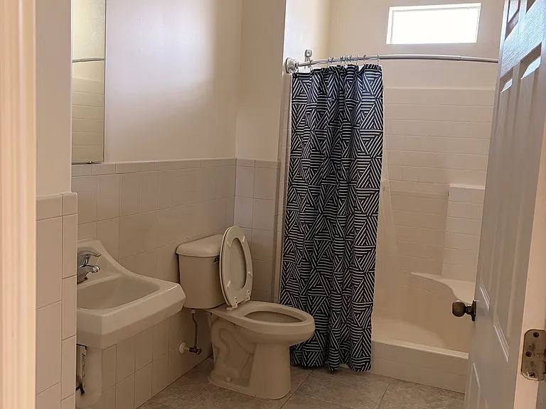 Main bathroom. Nice and spacious with connected utility closet.