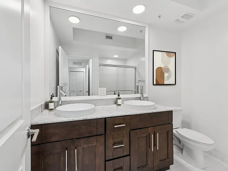 Renovated Package II bath with quartz countertop and oak cabinetry (in most homes)