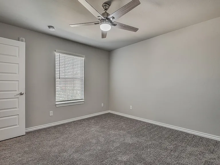 Relax and unwind in this inviting and spacious bedroom, designed with comfort in mind.