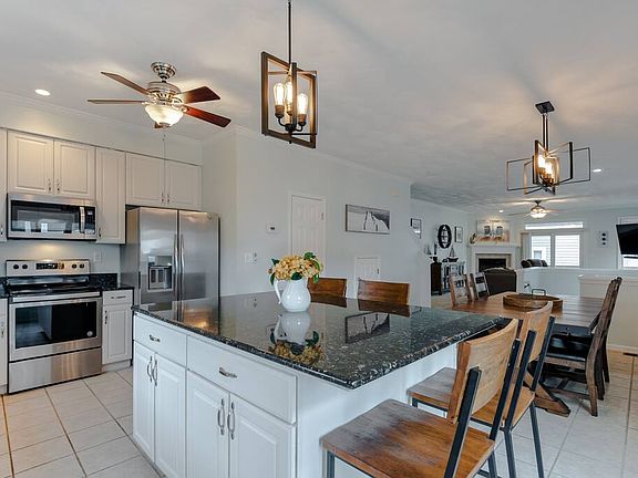 Gorgeous, modern lighting illuminates this spacious kitchen!