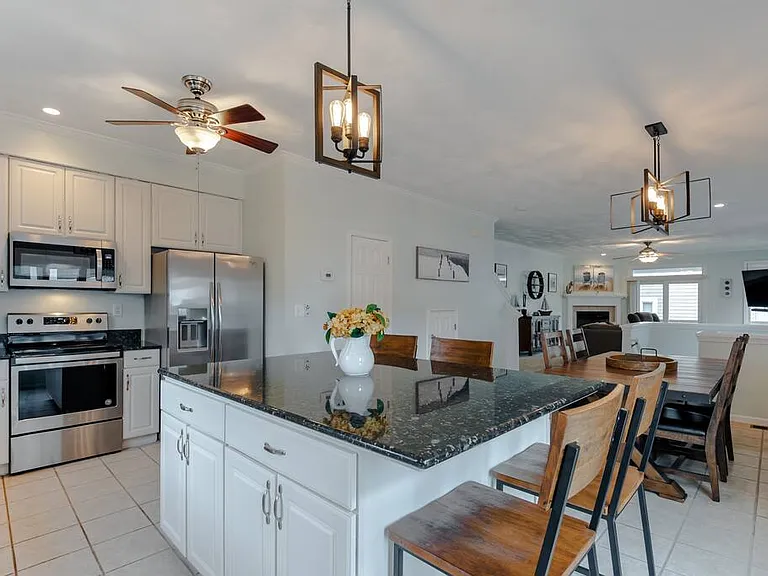 Gorgeous, modern lighting illuminates this spacious kitchen!