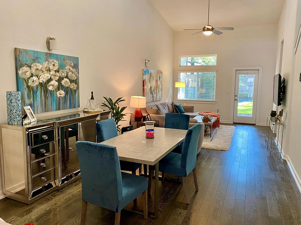 open layout with 2 story ceilings and natural light from high windows