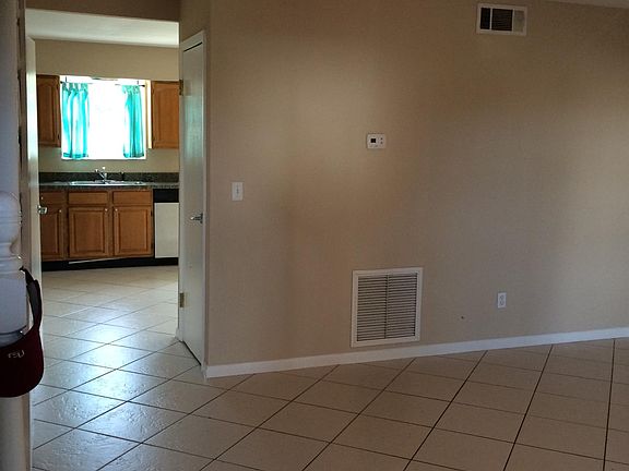 The guest half-bath is to the left in the pass-through to the kitchen