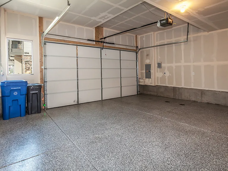 Oversized attached garage with epoxy floors.