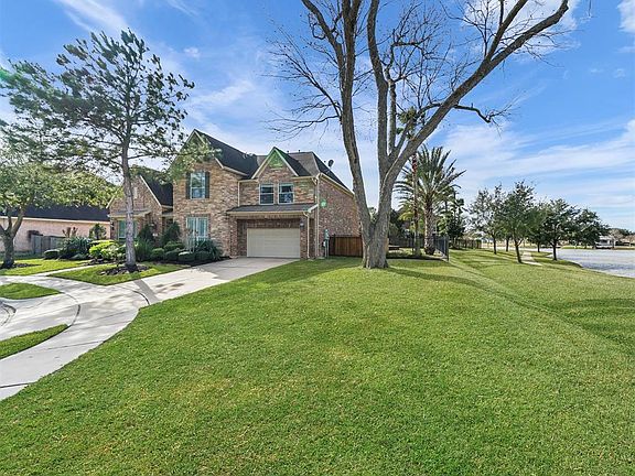 This wonderful home has gorgeous curb appeal with plenty of greenspace and lake views. The wide driveway leads to a double car garage with tandem that has been converted to a storage room (would make a perfect workshop/craft room/workout space/studio