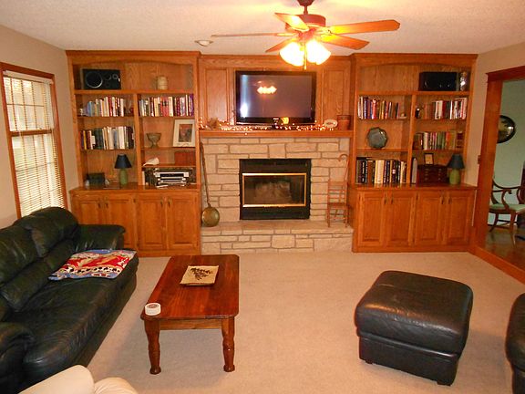 Sunken living room with gas fireplace; oak bookshelves