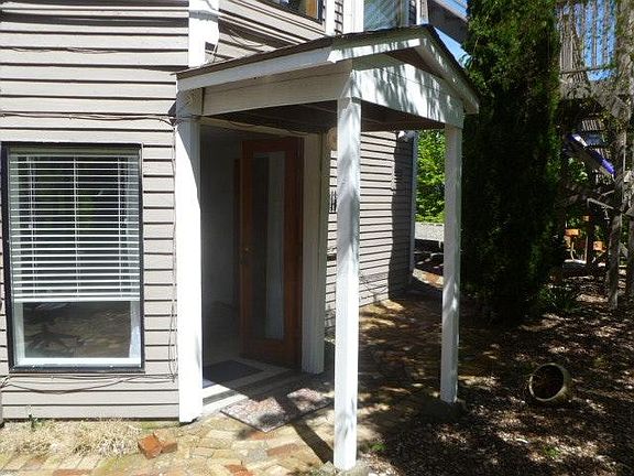 Separate private entry with brick sidewalks and patio area