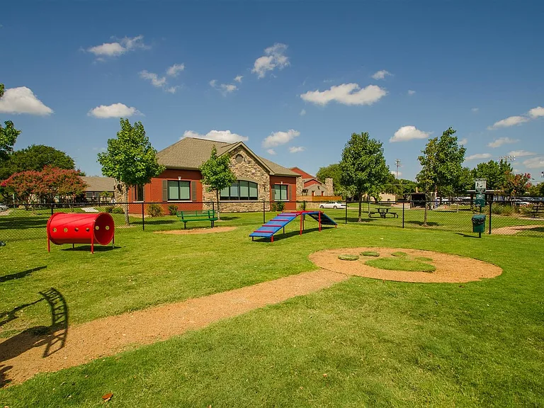 Pet-friendly community featuring a dedicated fenced dog park with ample space for exercise and socialization.