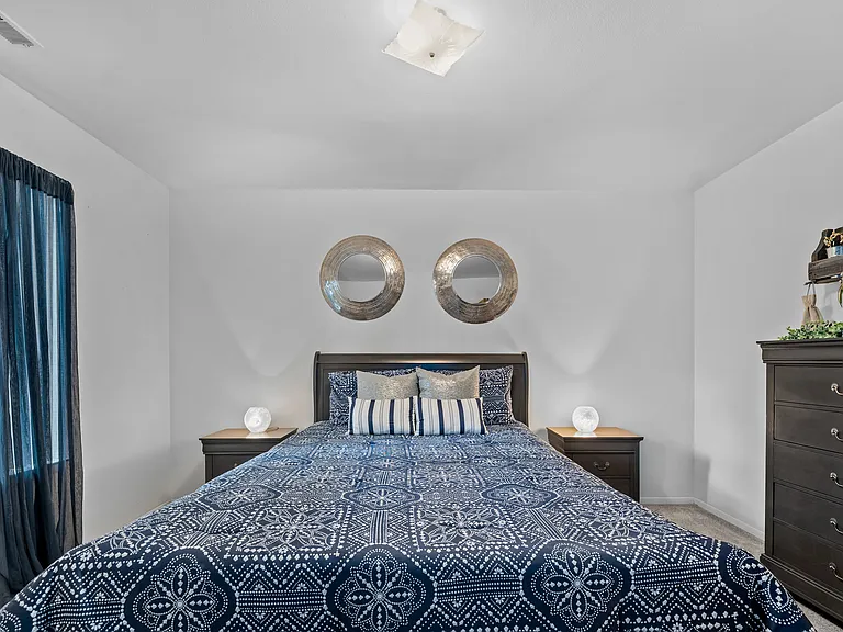 Comfortable bedroom with natural lighting at Westwood Village Apartments in Westland, MI