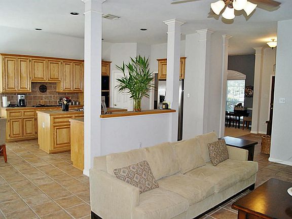 VIEW THROUGH DEN AND BREAKFAST BAR TO KITCHEN
