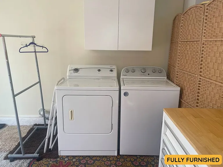 Laundry is located in the bonus space off the downstairs bedroom, also accessible via the double glass doors off the backyard patio.