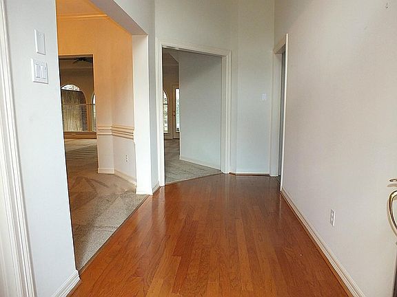 The foyer is open to the dining room and den