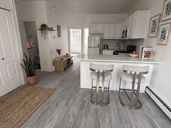 Open Concept Living & Kitchen Area- Living- This room has been virtually staged using AI to help visualize its layout and design potential.