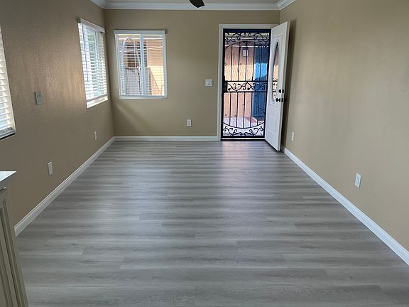 Looking out from the Living Room, door open, screen closed