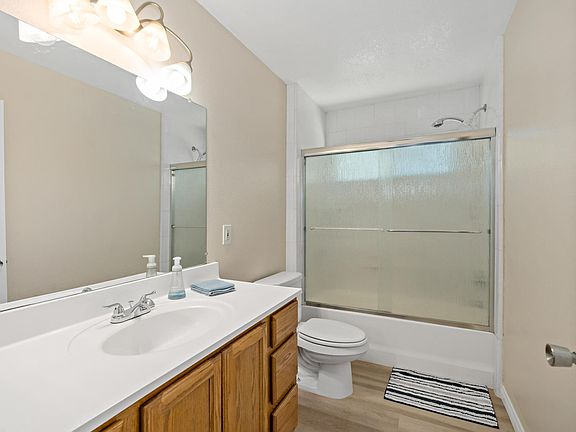 Experience the modern comforts of our pristine shared bathroom, boasting clean lines, newly renovated fixtures, and ample storage space in stylish cabinets.