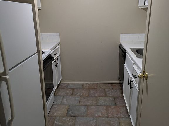 view of kitchen which contains refrigerator and stove with oven, dishwasher, and microwave oven