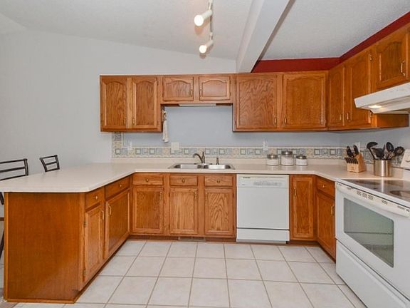The kitchen is open to the dining area, has ceramic tile floors.