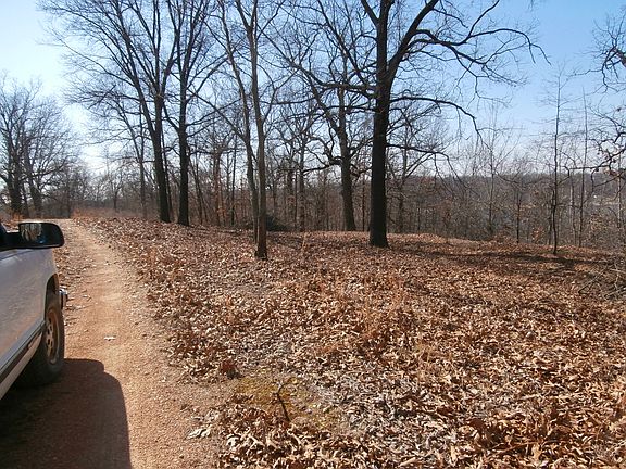 View of dirt road by lots