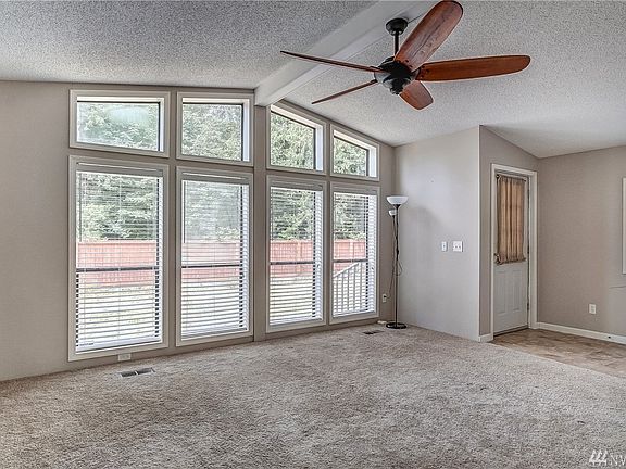 The bright and light living room has loads of natural light from the large floor to ceiling windows. 