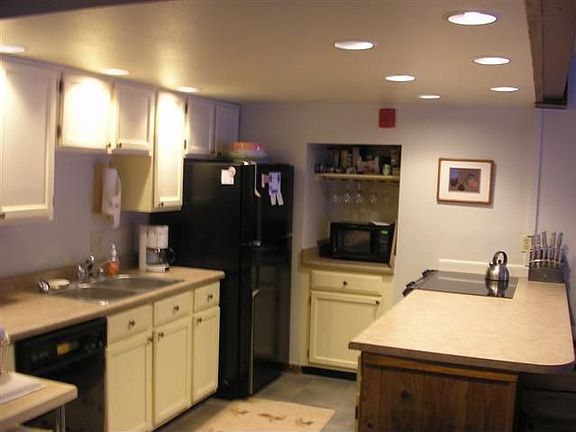 Kitchen has newer black appliances.