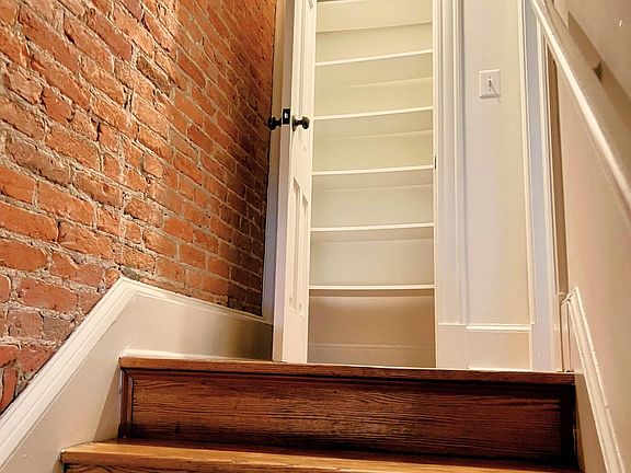 Storage closet atop entryway stairs