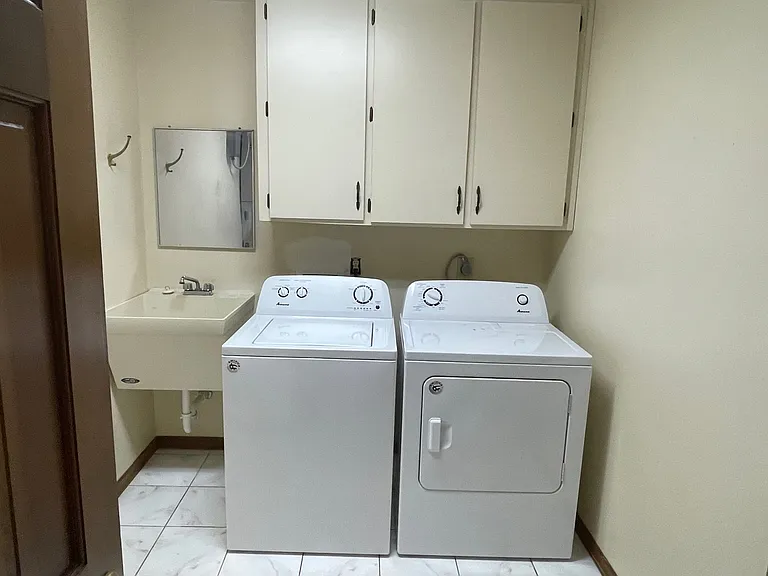 Laundry room with washer, dryer and mop sink