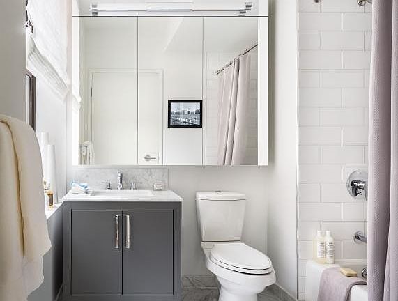 The Arlington's luxurious baths feature Italian marble floors, custom wood cabinetry, and oversized