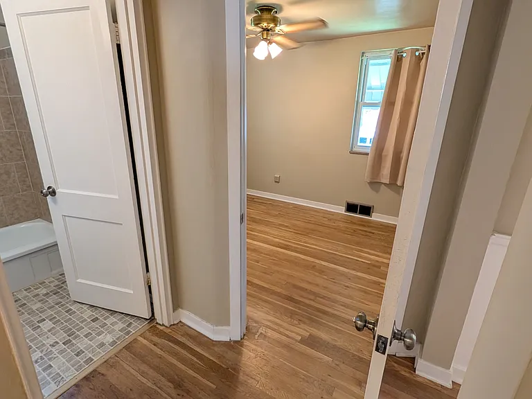 view from living room into bathroom and main floor bedroom