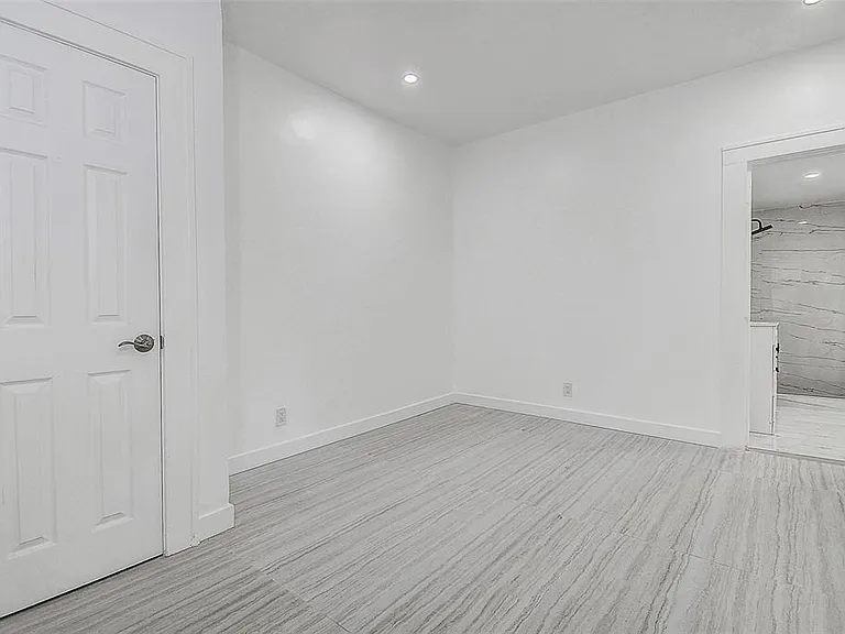 The primary suite includes an ensuite bath, while three additional bedrooms provide ample space and natural light.