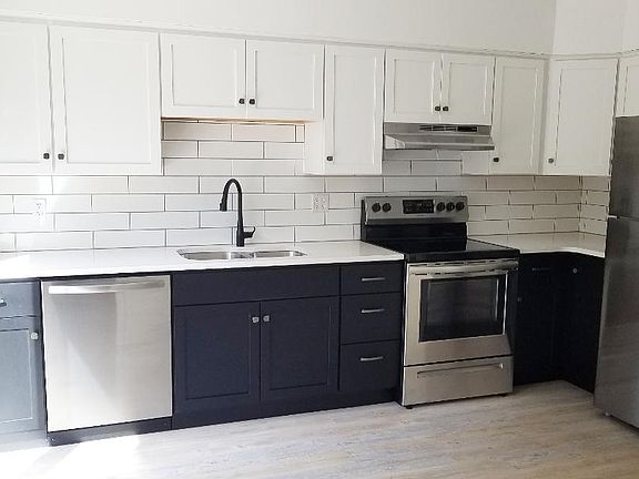 Kitchen with White Quartz Counter tops and Stainless Steel Appliances