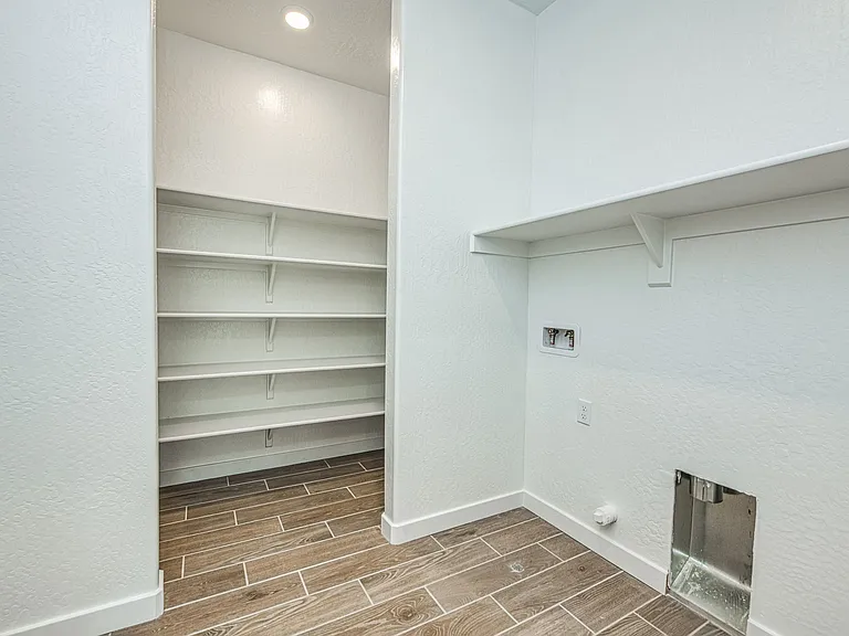 Laundry room upstairs with large storage area