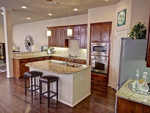 Open Kitchen with Breakfast Bar, Walk-In Pantry, Granite Counters with Custom Backsplash and Stainless Appliances