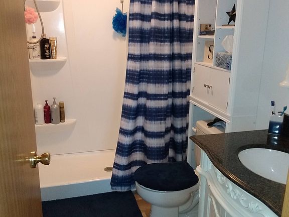 Lower level bathroom, full bath with bathtub on upper floor.