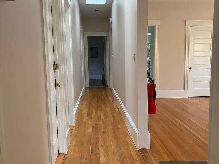 Hallway runs through entire apartment separating common areas from bedrooms. Two huge bright skylights.