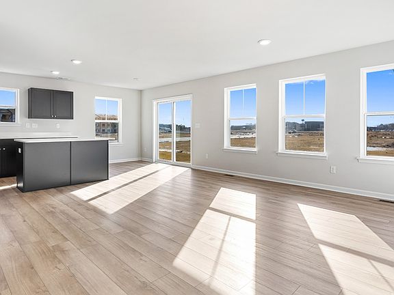 Open kitchen and family room in a DRB Homes Cranberry II plan in the Village of College Park communi