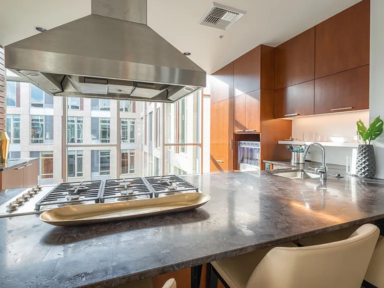 Demonstration kitchen with gas cooktop in the resident lounge