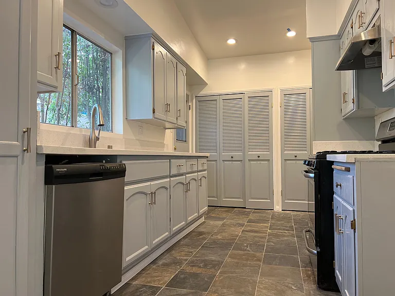 Kitchen with stainless appliances and quartz countertops