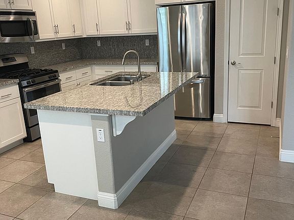 Kitchen island large enough for several barstools.