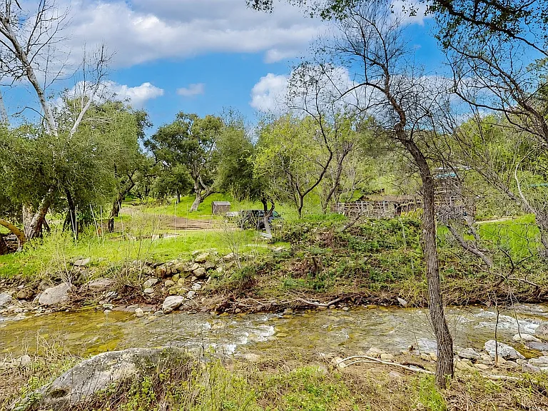 Across from seasonal creek and steps to trail