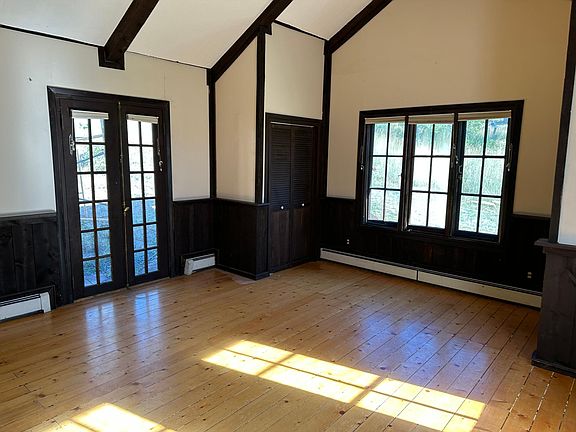 Main floor large bedroom french door, wood floors throughout, lots of windows & natural light