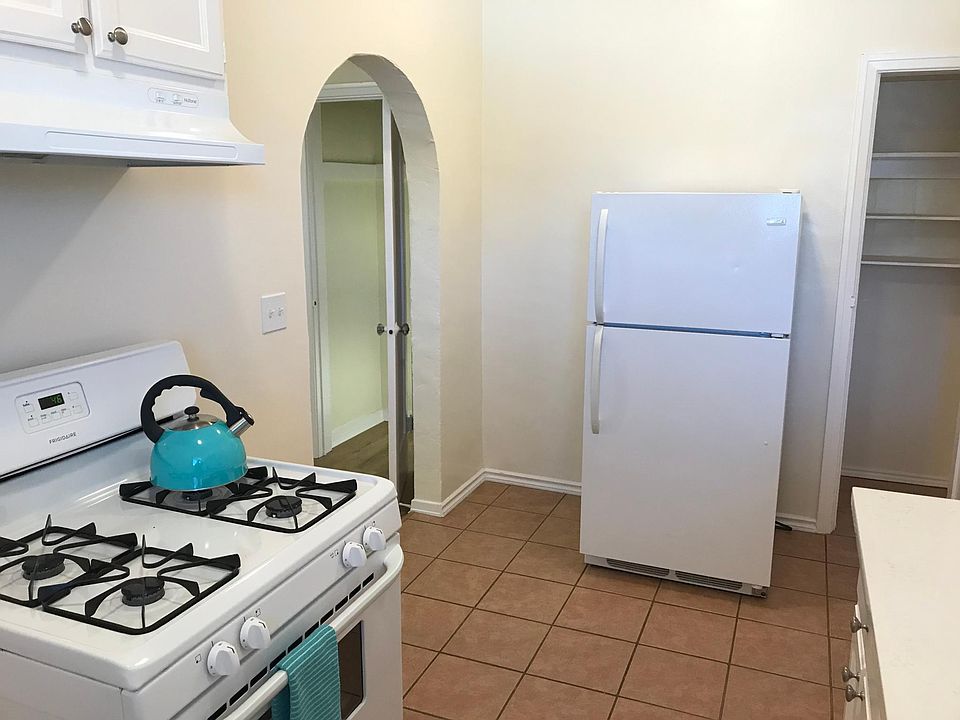 Kitchen equipped with major appliances, white-quartz countertop, narrow but deep cupboard storage space located in Kitchen.