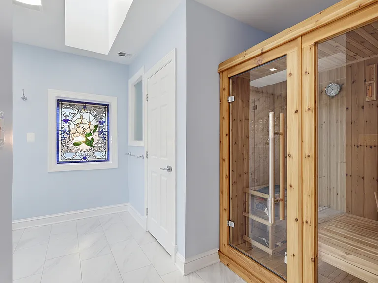 Cedar sauna and glass window in primary bath.