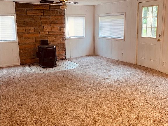 New carpet in living room with a wood stove