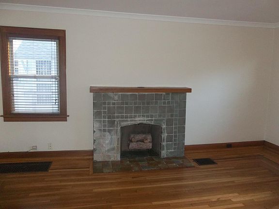 Living room as seen through entrance hall at the front door. 
ROOM SIZE: 18' x 12'