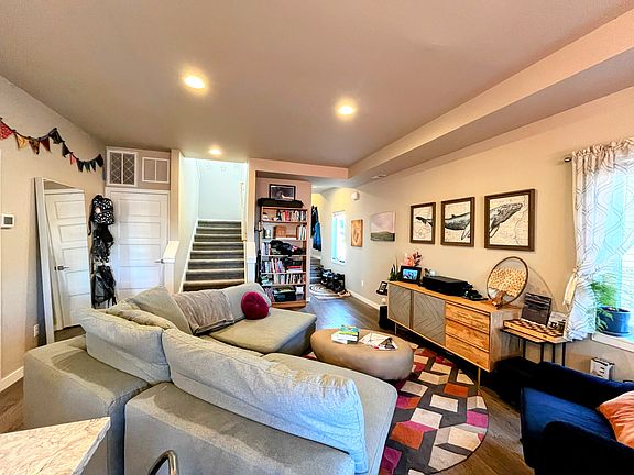 Open floor plan living space on main level with kitchen behind and out of frame