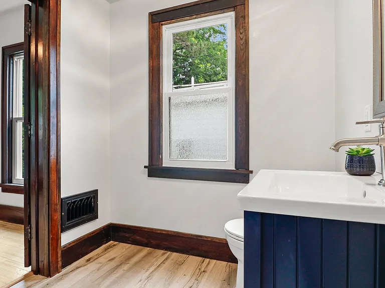 Shot from the shower showing entrance from bathroom into bedroom.